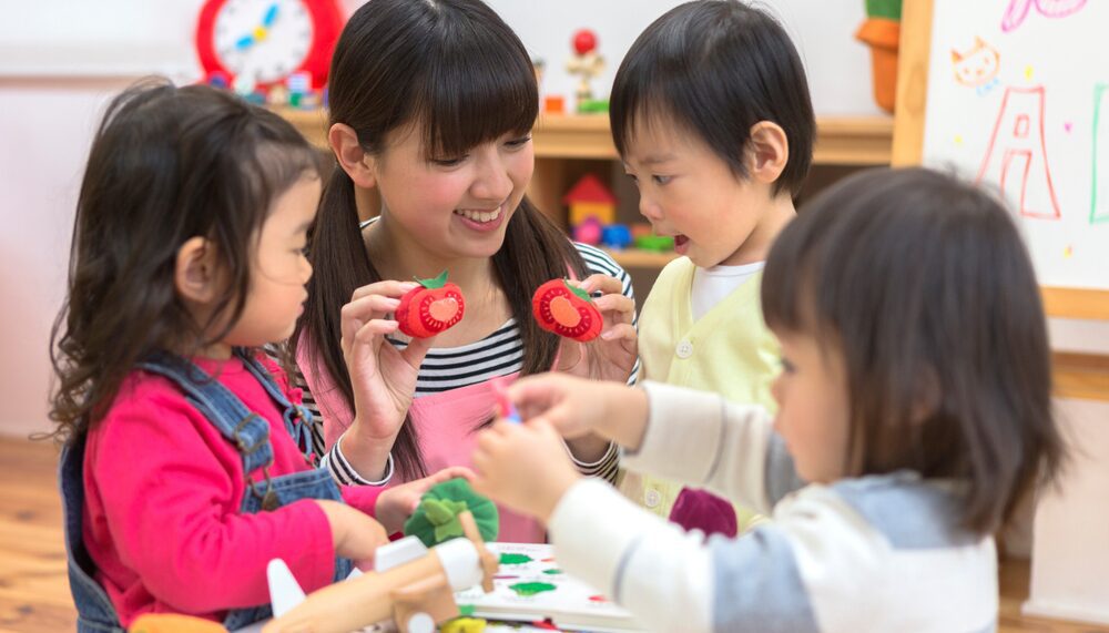A group of children play with toys in a room.
