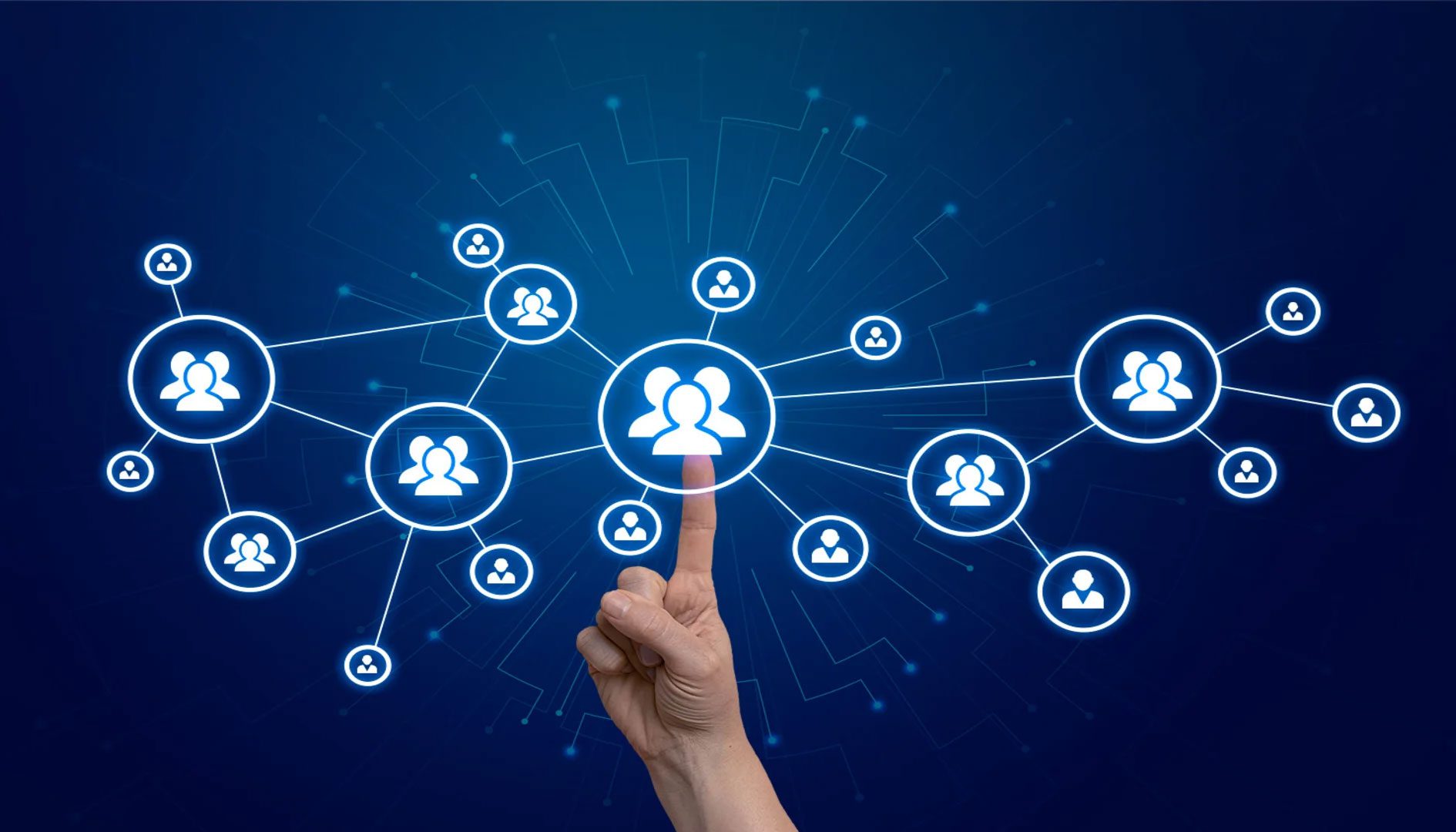 A hand is pointing to the center of a group of people.