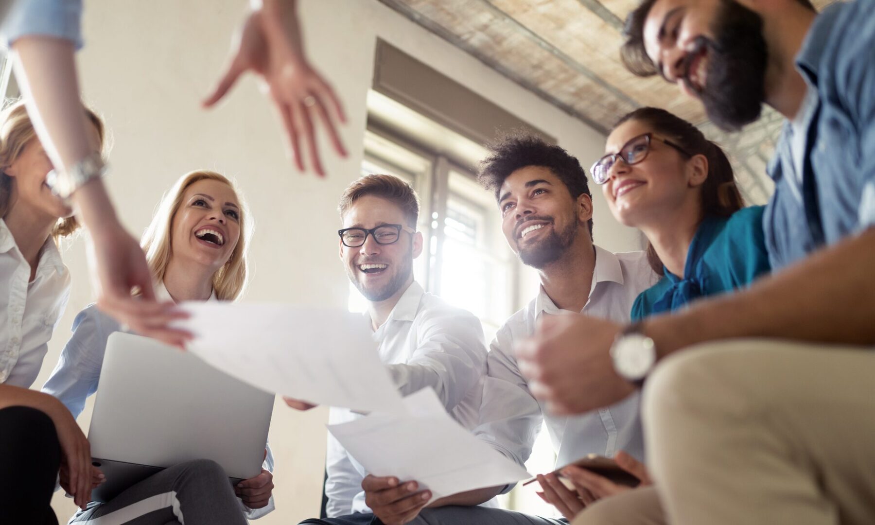 A group of people sitting around each other.