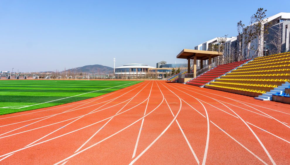 A track and field stadium with an empty running track.