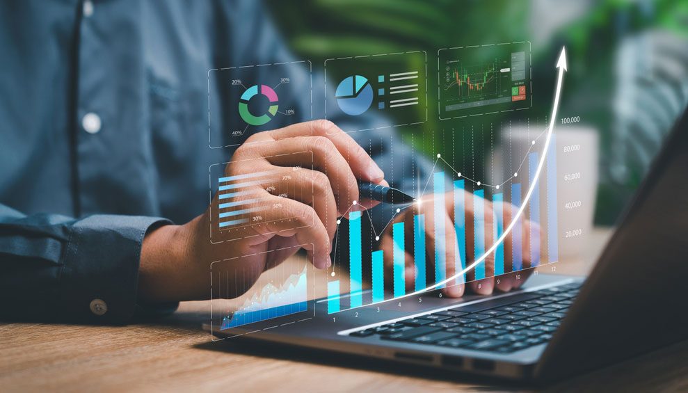A person is using their laptop to analyze data.