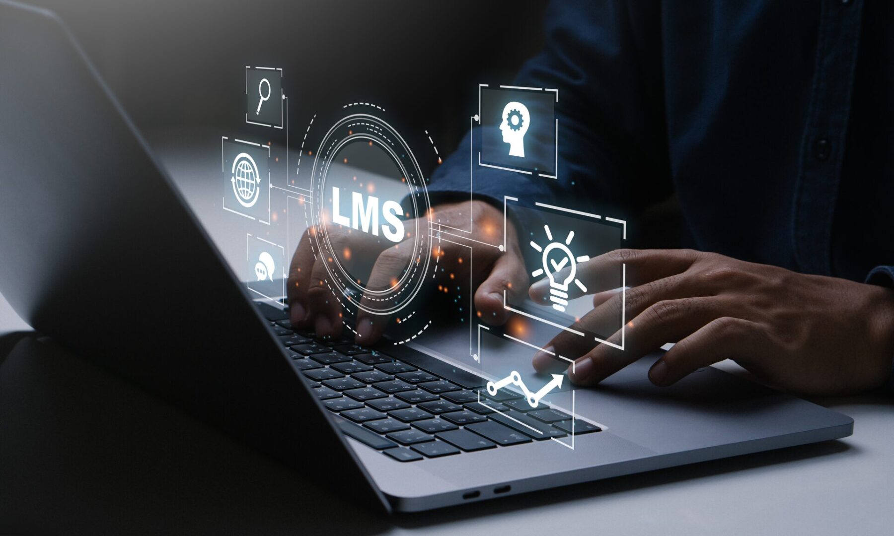 A person is using a laptop with icons on it.